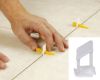 Immagine di BASE LIVELLANTE PER PIASTRELLE FUGA 1,5 MM H. 3-12 MM CONFEZIONE 100 PZ RAIMONDI